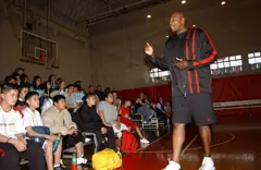 US Navy 030328-N-3503M-001 Former NBA player Jerome Kersey addresses a group of kids on the basketball court in the Naval Air Facility, Ranger Gym.jpg